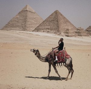 Cordae Riding Camel In African Sahara