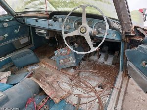 Inside, the two front seats are missing and its gearbox, the carpet had deteriorated and the radio and control column was hanging off, leaving wires exposed. Due to the poor state of the barn it had been kept in, the outside blue body of the car was covered in a combination of rust and lichen.