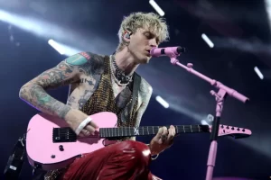 Born in 1990, Machine Gun Kelly grew up in various parts of the United States and overseas due to his parents’ military background. The rapper’s love for music began at a young age and he ultimately broke into the rap scene in the early 2010s. The release of his mixtape, 100 Words And Running gained significant attention and helped build his loyal fanbase. He signed a deal with Bad Boy and Interscope Records before propelling to stardom with the release of his hit single “Wild Boy” in 2012. Expanding His Musical Horizons